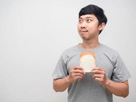 Young man hungry gesture stick out tongue for eatting sandwich in hand photo