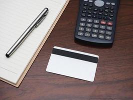 Credit card with calculator workspace on table top view photo