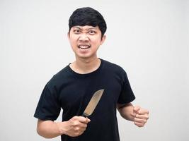 Mad man with circle under eyes holding knife gesture angry photo