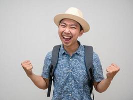 Cheerful traveler man with backpack feels satisfied happy photo