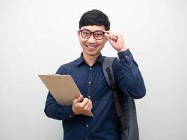 Man touch his glasses with backpack holding document board happy smile photo