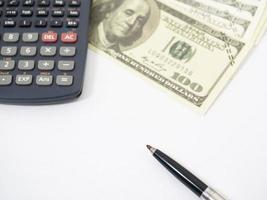 Close up pen with calculator and money isolated white photo