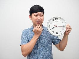 Man looking at clock feel shocked at face with working late isolated