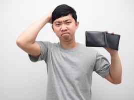 Man strain about no money holding empty wallet in hand photo