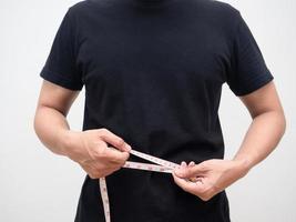 Man using measure tape body for checking his waist studio shot photo