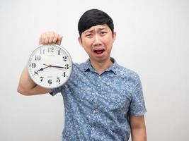 Man holding analog clock feel shocked at face with working late isolated