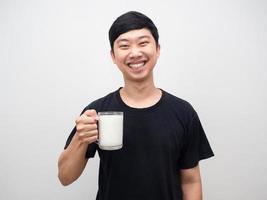 Portrait young man healthy holding glass of milk happy smiling photo