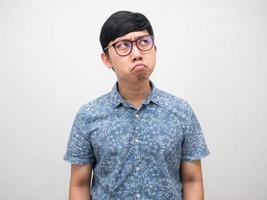 Asian man wearing glasses doubt emotion looking up copy space photo
