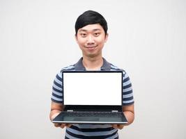 Asian man gentle smile striped shirt holding laptop white screen photo