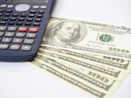 Close up calculator with a lot of money on workplace isolated photo