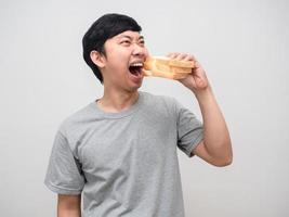 Asian man very hungry eatting sandwich portrait photo