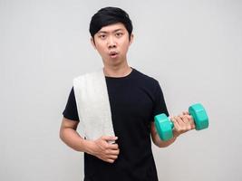 Young man workout with dumbbell feels tried isolated photo