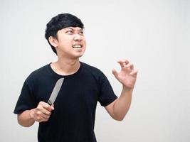 Mad man with circle under eyes holding knife gesture attack copy space photo