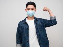 Positive man jeans shirt wear medical mask good healthy show muscle photo