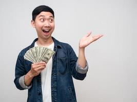 Asian man jeans shirt hold money dollar gesture suggest photo