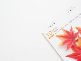 Maple leaf on the calendar top view copy space white autumn concept photo