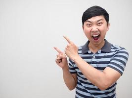 Shocked man striped shirt excited double point finger at copy space photo