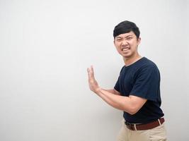 Young man gesture heavy push isolated photo