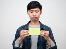 Portrait man jeans shirt hold post it isolated photo