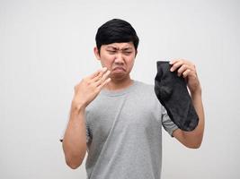 Young man smelly with dirty socks portrait photo