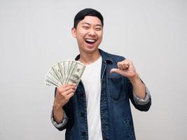 Cheerful man jeans shirt smile and happy about earn money point finger at himself isolated photo