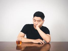 Man alcoholism hangover sitting and close his face feels bored photo