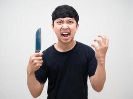 Crazy man with circle under eyes holding knife gesture angry photo