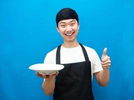 Chef man showing empty dish happiness smile thumb up blue background photo