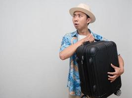 Young man beach shirt wear hat hold luggage feels amazed isolated photo