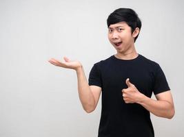 Asian man show empty hand with thumb up for carry product photo