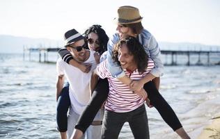 Young people having fun by a lake. Young friends relaxing by a lake. photo