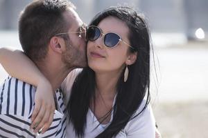 Picnic holiday concept. Beautiful couple having fun making BBQ on bonfire and relaxing by a lake. photo