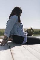 Picnic holiday concept. Beautiful couple having fun and relaxing by a lake. photo