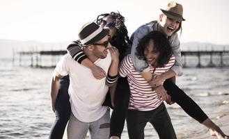 Young people having fun by a lake. Young friends relaxing by a lake. photo