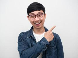 Portrait man wearing glasses jeans shirt happiness smile point finger isolated photo