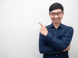 Asian businessman wearing glasses cheerful smile point finger at copy space photo