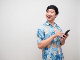 Cheerful man smile hold smartphone for booking at holiday turn face looking copy space photo