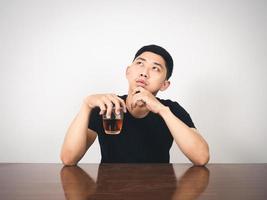 Asian man with alcohol in hand sitting feels depressed photo