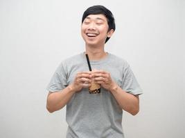 Positive man hold boba tea feels happiness with smile photo