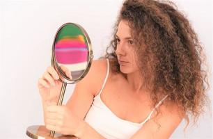 woman with curly hair and beautiful healthy face skin look at camera and posing. Beauty concept photo