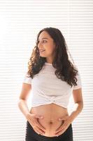 Pregnant woman touching her belly. Pregnancy and maternity leave photo