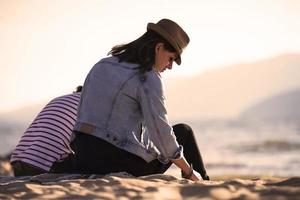 back view of a Happy Romantic Couple Enjoying Beautiful Sunset on the Beach. Travel Vacation Retirement Lifestyle Concept photo