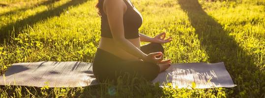 Banner pregnant woman meditating in nature, practice yoga copy space and empty place for text. Care of health and pregnancy photo