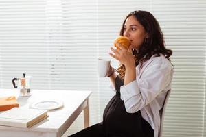 Pregnant woman eating breakfast. Pregnancy and maternity leave photo