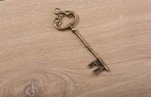 retro styled decorative key on wooden texture