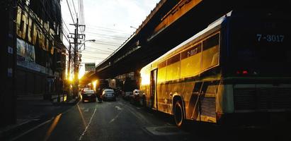 Bangkok, Thailand - January 1, 2023 Many vehicle stuck on road and highway or bridge on top with sunlight of sunset or sunrise. Traffic jam in city or town. Rush hour time for people travel on street. photo