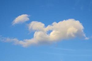 Fluffy cloudy above summer sky background photo