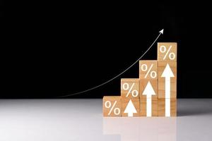 Interest rate and dividend concept, wooden block with percentage symbol and up arrow, Interest rates continue to increase, return on stocks and mutual funds, long term investment for retirement. photo