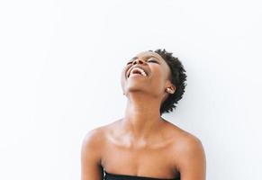 Portrait of emotional young African American woman in black top isolated on white background photo