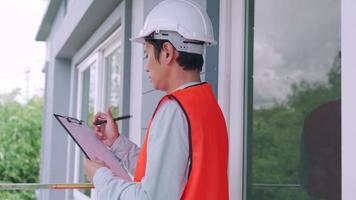 inspector or engineer is inspecting and inspecting a building or house using a checklist. Engineers and architects or contactor work to build the house before handing it over to the homeowner. video